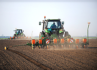 a tractor working on a field with Farm Insurance in Burlington, IA, Stronghurst, IL, Galesburg, Monmouth, IL, Oquawka, IL, Biggsville