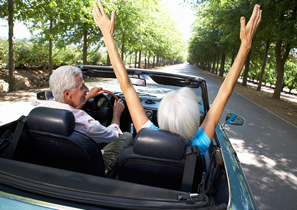 couple enjoying convertible car  with the cheapest car insurance in Burlington.