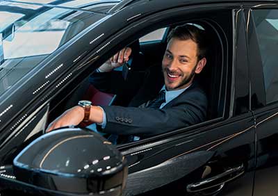 Man inside of a black car with Auto Insurance in Burlington, IA, Stronghurst, IL, Galesburg, Oquawka, IL, and Surrounding Areas