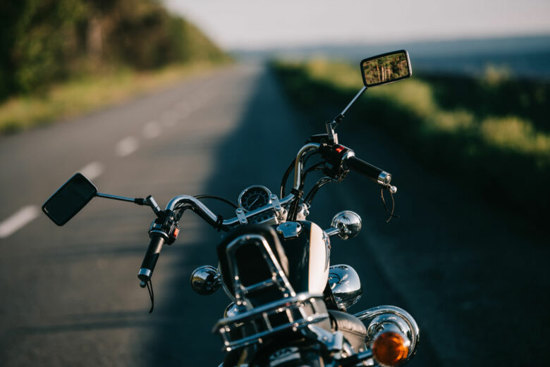 a black motorcycle parked on a highway with Motorcycle Insurance in Galesburg, Burlington, IA, Stronghurst, IL, Oquawka, IL, Monmouth, IL, Biggsville